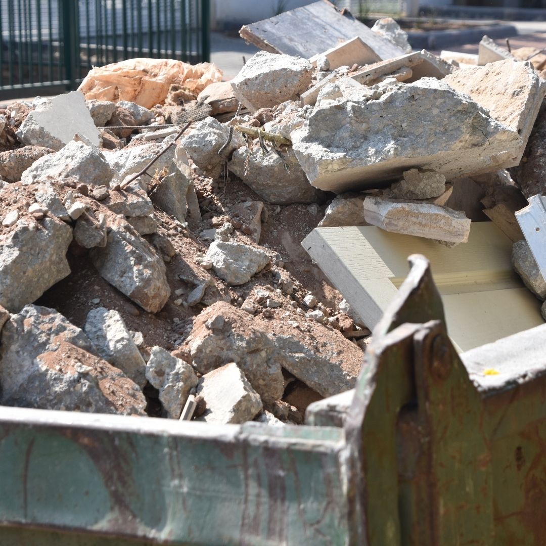 concrete rubble stacked up in a waste bin