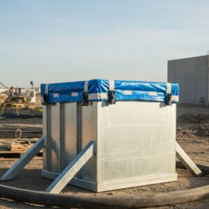 Close-up of watertight, sealed concrete washout container in bright daylight